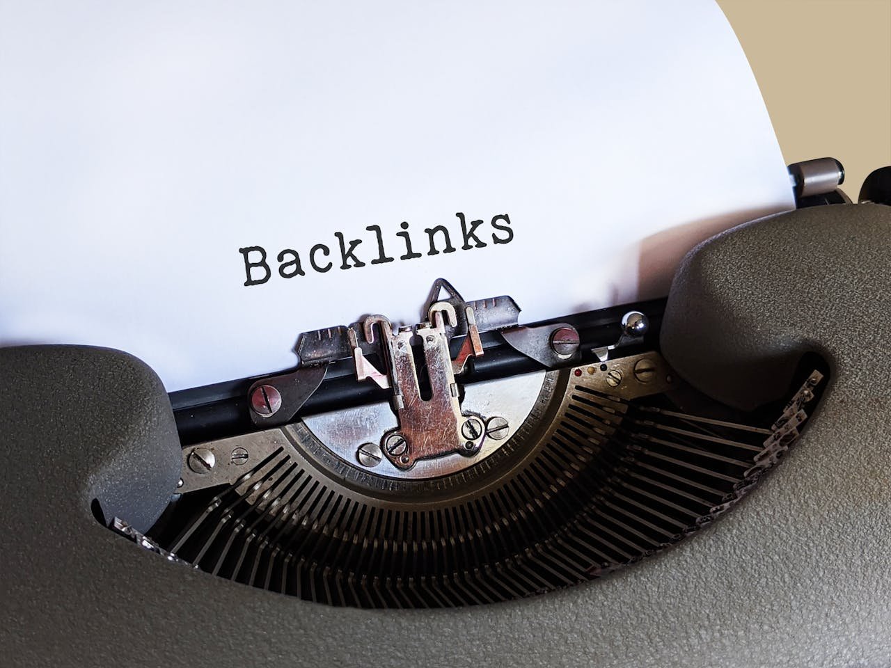 who-we-are Close-up of a vintage typewriter printing the word 'Backlinks,' emphasizing content and SEO concepts.